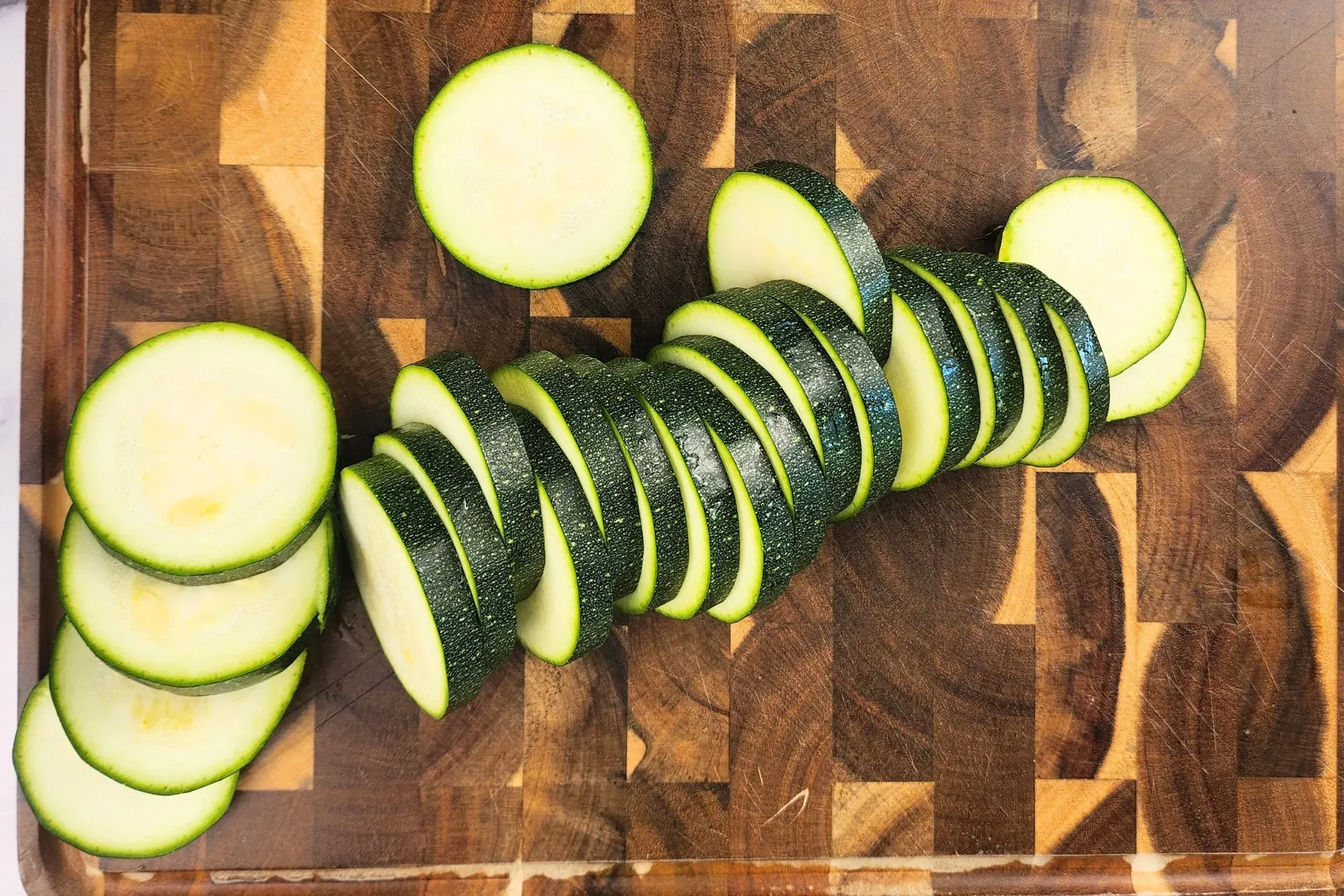 Sliced zucchinis on a wooden board