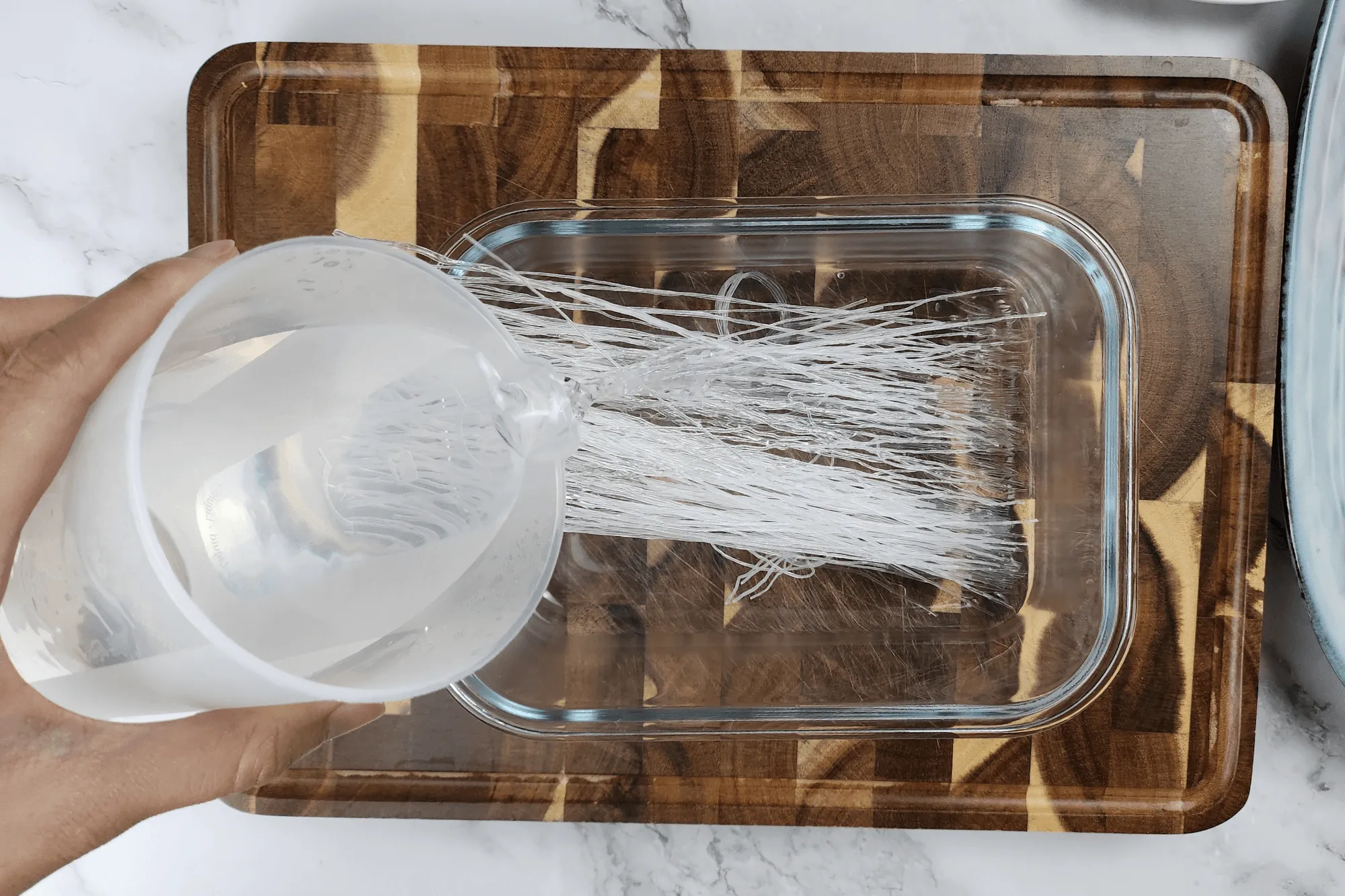 Soak the glass noodles in room temperature water until they become soft. 