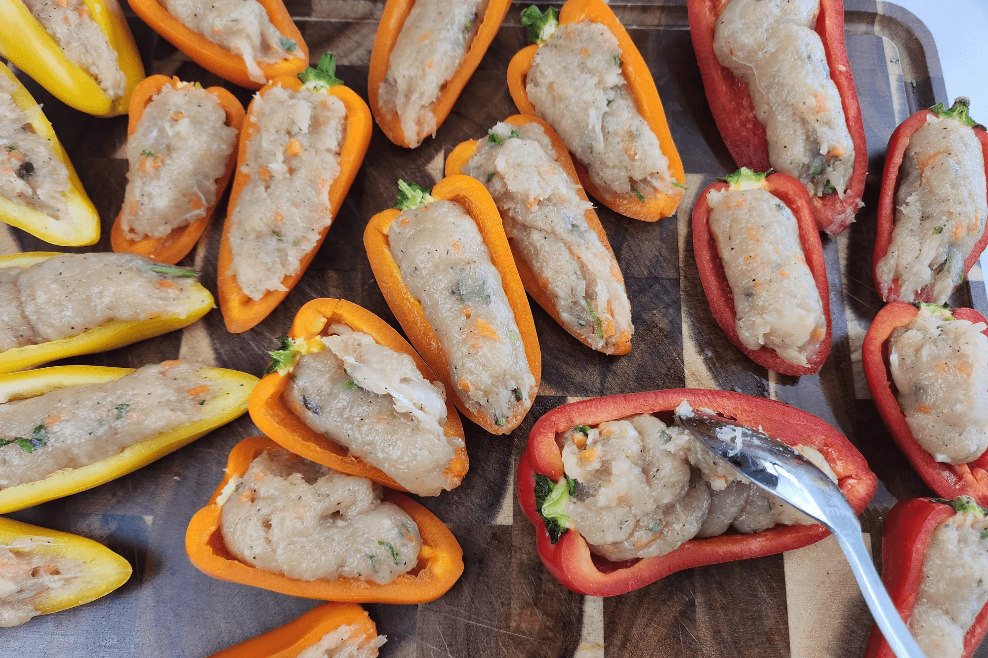 Spoon the chicken mixture into each pepper packing it tightly. Smooth the tops for even cooking.