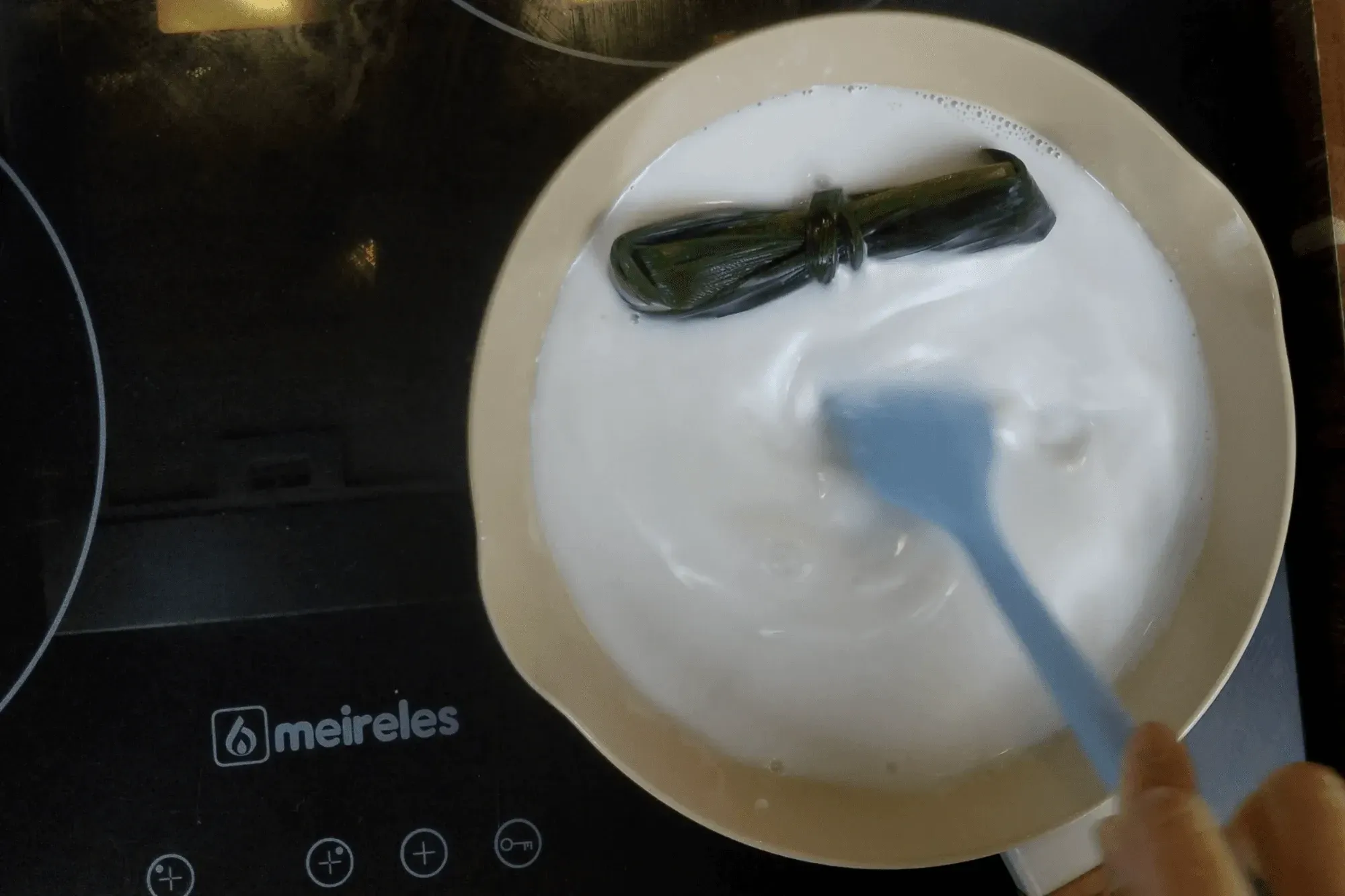  the coconut milk starts to simmer gently 