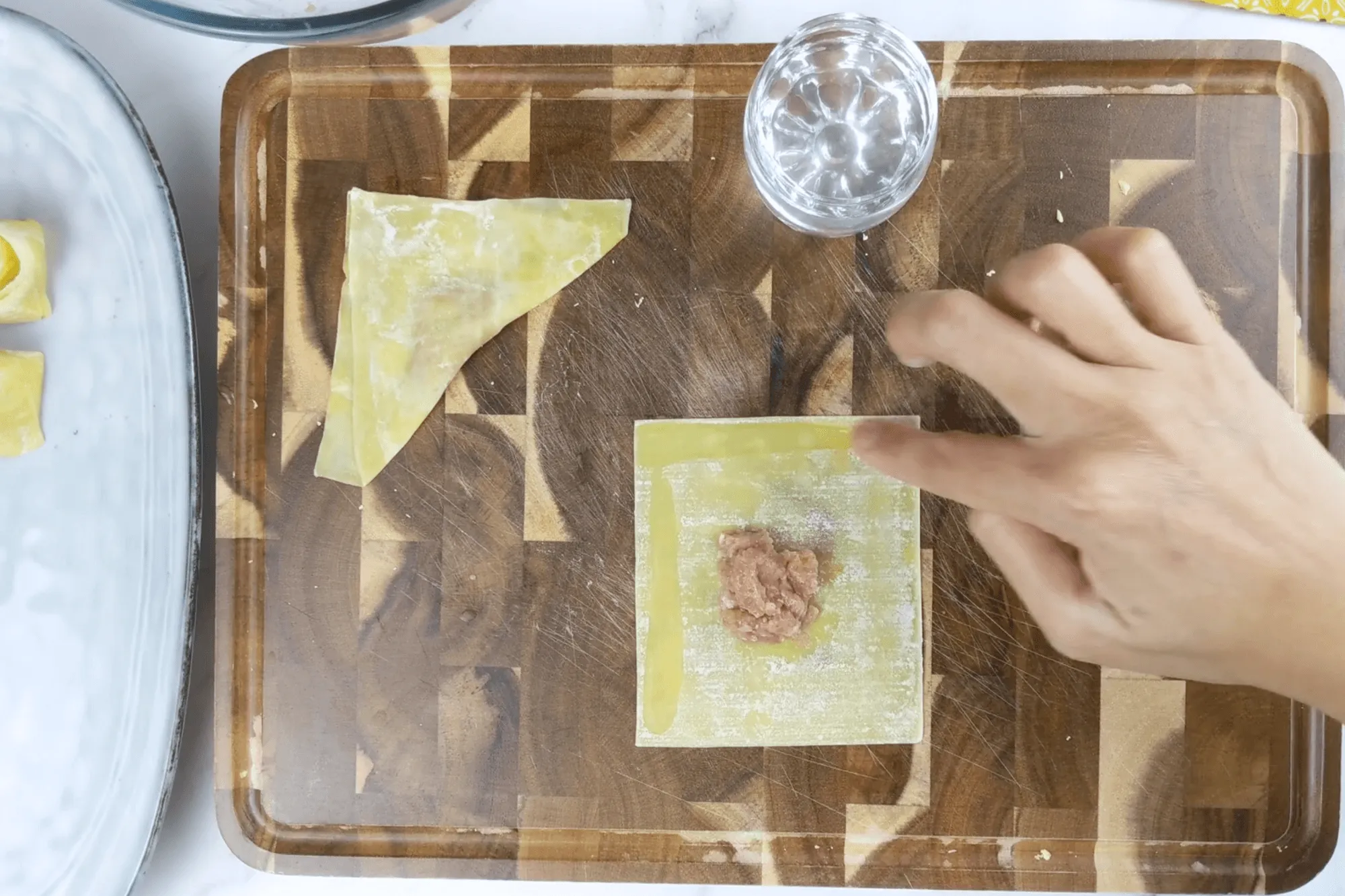 Wrap the wontons using water as a sealant to keep them together.